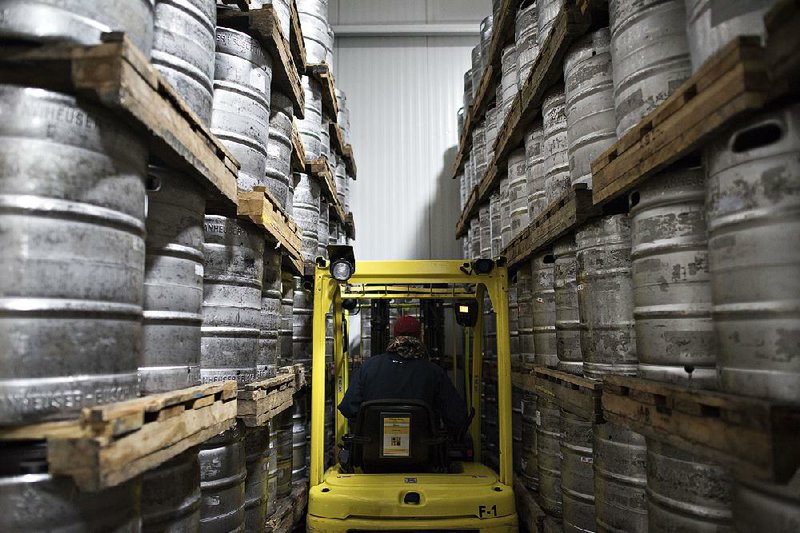 A warehouse employee moves kegs of Anheuser-Busch beer at Brewers Distributing Co. in Peoria, Ill., in this file photo. Anheuser-Busch InBev confirmed Wednesday that it would like to buy SABMiller, the second-largest global brewer. 
