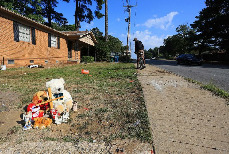 A makeshift memorial at 10010 Chicot Road in Little Rock marks the scene Wednesday where two women were struck, one of them fatally, by a vehicle that went out of control while being chased Tuesday evening by a Little Rock police cruiser.