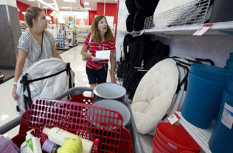 Boston University student Ashley Babula (left) shops for back-to-school items with her mother, Mary, last month at a Target store in Boston. U.S. consumer prices fell in August, the Labor Department said Wednesday. 