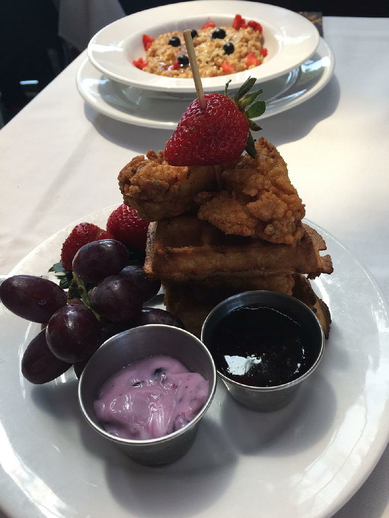 Chicken and Waffles (front) served with fruit and War Eagle Steel-Cut Oatmeal are on the Sunday brunch menu at Eleven at Crystal Bridges.