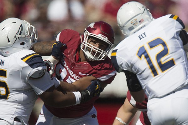 Arkansas defensive lineman DeMarcus Hodge is blocked during a game against Toledo on Saturday, Sept. 12, 2015, at War Memorial Stadium in Little Rock. 