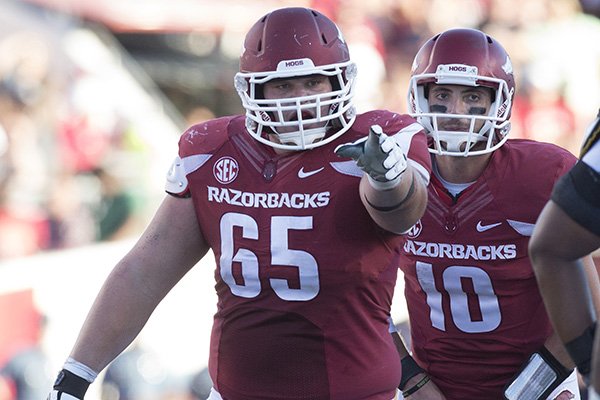 Arkansas center Mitch Smothers (65) lines up in front of quarterback Brandon Allen during a game against Toledo on Saturday, Sept. 12, 2015, at War Memorial Stadium in Little Rock. 
