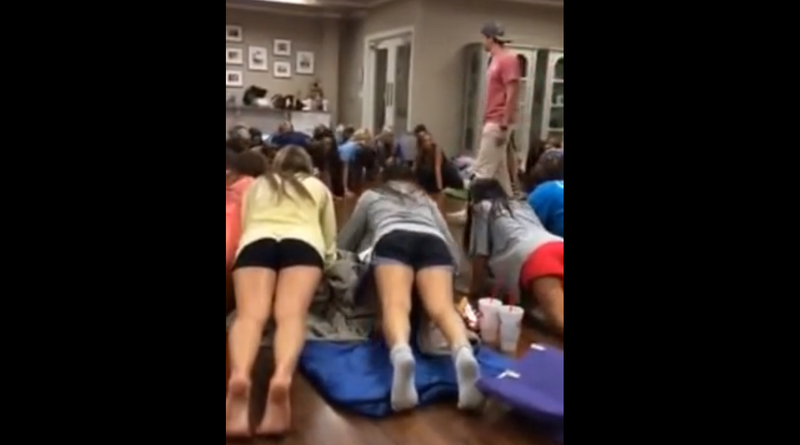 Alpha Sigma Tau sorority members at the University of Central Arkansas are seen taking orders from an upperclassman fraternity member in a still from video footage submitted to the university's student newspaper, The Echo. 