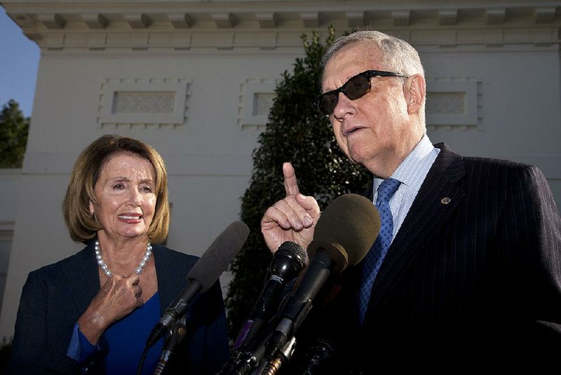Senate Minority Leader Harry Reid of Nevada, with House Minority Leader Nancy Pelosi of California., talks to reporters Thursday outside the West Wing of the White House in Washington after a meeting with President Barack Obama.
