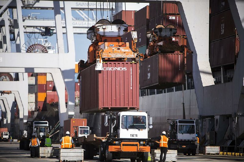 Shipping containers are loaded on trucks at the Port of Savannah in Georgia. The U.S. trade defi cit shrank to $109.7 billion in the second quarter, down from $118.3 billion in the first quarter, the Commerce Department said Thursday. 