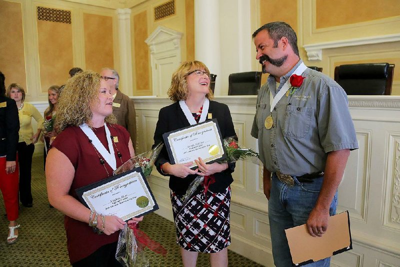 Meghan Ables (left), with Stuttgart High School, Brenda Galliher, from Nashville Junior High School, and Michael Rogers, with Siloam Springs High School, chat after an Arkansas Teacher of the Year recognition event Thursday at the Capitol.