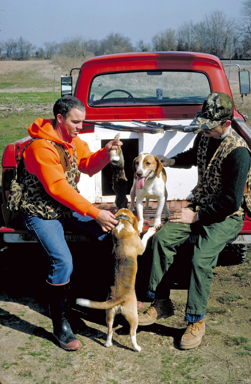 James Cansler, left, and Lewis Peeler of Vanndale praise their hard-working beagles for a successful hunt in Cross County.