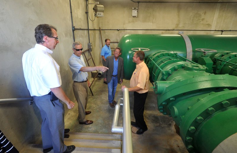 Bill HagenBurger (from left), plant engineer, Bill Watkins, board member, Chris Weiser, board member, Woody Bassett, board member, and Stacy Cheevers, plant manager, take a look around the pipe gallery Thursday.