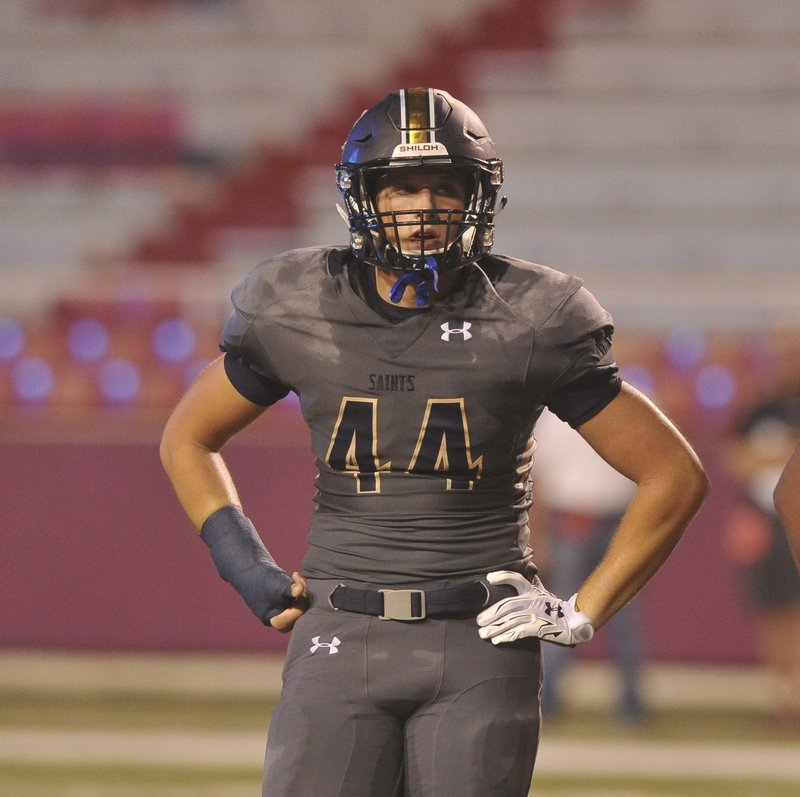 Shiloh Christian senior linebacker Lakin Hall looks to the sideline Sept. 1 for a defensive signal during the Saints’ season-opener against Charleston in Razorback Stadium. Hall was diagnosed with diabetes at the age of 13 but continues to play football at a high level for the Saints.