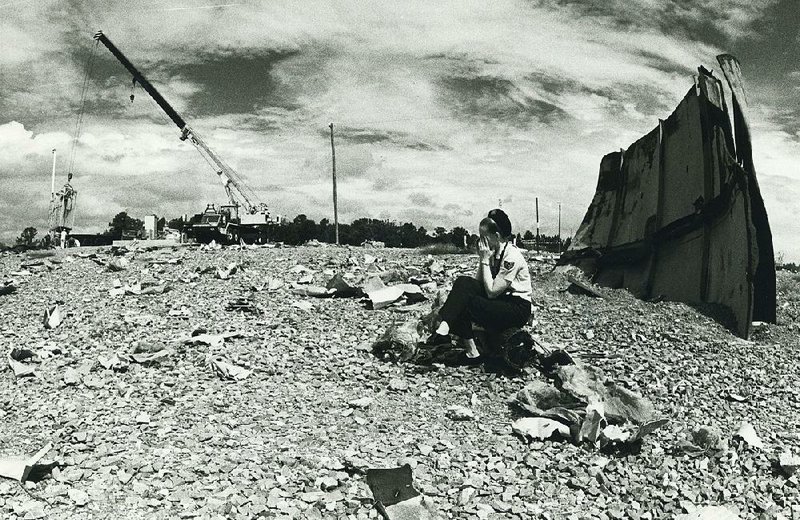 Staff Sgt. Virginia Sullivan, a public information officer at Little Rock Air Force Base when this photo was taken Aug. 27, 1981, sits in the debris field created by a fatal explosion Sept. 19, 1980, at Titan II missile silo 374-7 north of Damascus. A maintenance team forgot to bring the right tool into the silo and instead tried to use an unauthorized wrench, setting in motion one of the most publicized disasters of the Cold War. 
