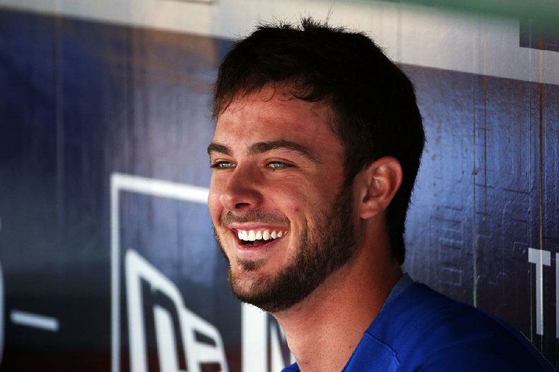 Chicago Cubs third baseman Kris Bryant sits in the dugout before the first baseball game of a doubleheader against the Pittsburgh Pirates in Pittsburgh, Tuesday, Sept. 15, 2015.