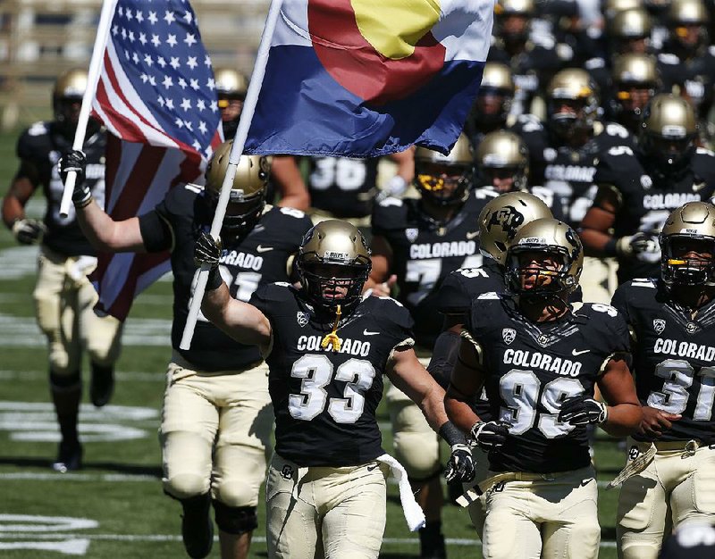 Colorado running back Jordan Murphy (33) and Colorado State offensive lineman Zack Golditch (not shown) will meet on the football field during today’s game in Denver.The two are survivors of the shootings at an Aurora, Colo., movie theater in July 2012.