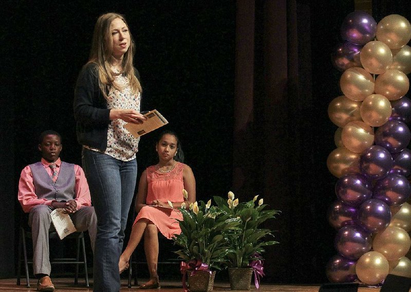 Chelsea Clinton shares some of her school memories during a visit Friday to Horace Mann Arts and Science Magnet Middle School in Little Rock. Behind her are students Reginald Brasfield and Kimberly Chacon-Sibaja. 