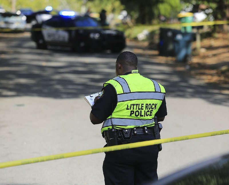 FILE — Little Rock police investigate near the intersection of 16th and Peyton streets after a homicide on September 19, 2015. 