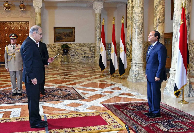 Egyptian President Abdel-Fattah el-Sissi (right) presides Saturday in Cairo over the swearing-in of Prime Minister Sherif Ismail.