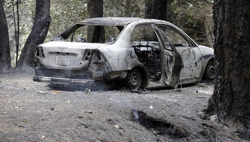 The charred remains of a car belonging to Leonard Neft, who has been missing since a wildfire tore through the area and destroyed his home days earlier, sits in the Anderson Springs area Wednesday, Sept. 16, 2015, near Middletown, Calif. 