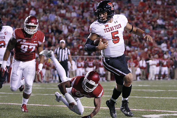 Arkansas defensive lineman Tevin Beanum (97) and defensive back Jared Collins chase Texas Tech quarterback Patrick Mahomes II during the second half of an NCAA college football game Saturday, Sept. 19, 2015, in Fayetteville, Ark. Texas Tech beat Arkansas 35-24. (AP Photo/Samantha Baker)