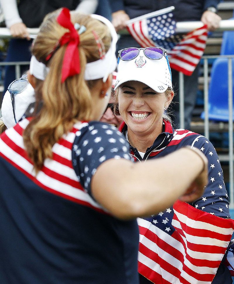 Paula Creamer of the United States celebrates after she won the fi nal point at the Solheim Cup in St. Leon-Rot, Germany on Sunday. Creamer defeated Germany’s Sandra Gal as the United States won the Solheim Cup with a 14½-13½ victory over Europe. Creamer made five birdies in 15 holes to win the final singles match 4 and 3 and helped give the U.S. its first title since 2009.

