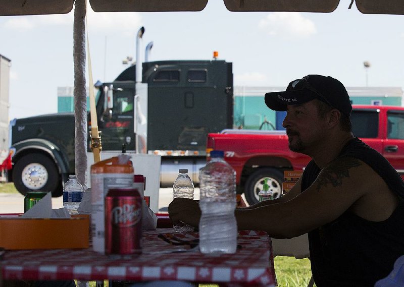 Bret Frenzel of Chicago eats a free lunch Thursday at the Petro Station in North Little Rock. Frenzel and other truckers were treated to a free meal and some games and music by the Arkansas Trucking Association.