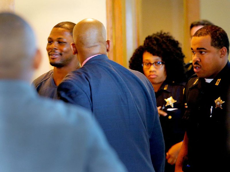 Boxer Jermain Taylor smiles as he is led into a courtroom for a hearing Monday in Pulaski County Circuit Court. 
