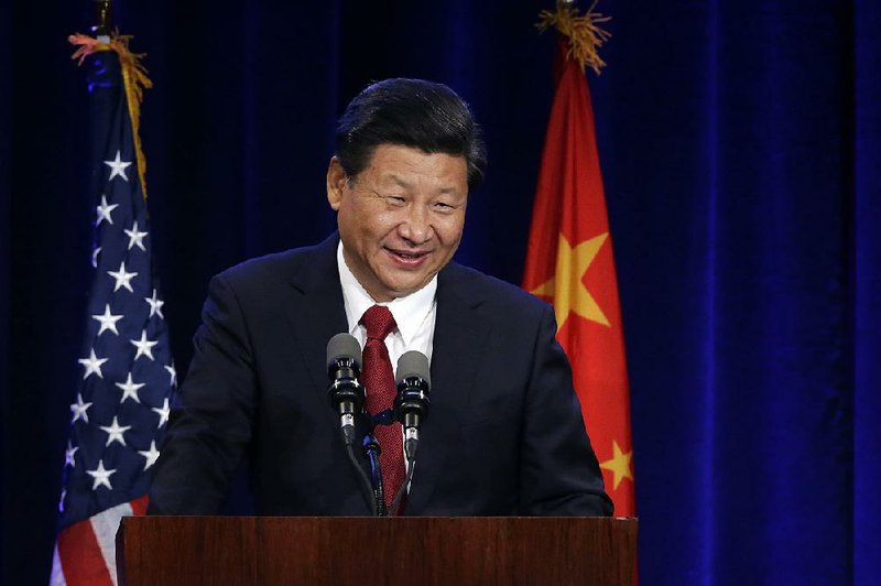 Chinese President Xi Jinping speaks Tuesday at a banquet in Seattle where he signed an agreement to work with the U.S. to advance renewable energy and clean technologies to combat climate change.