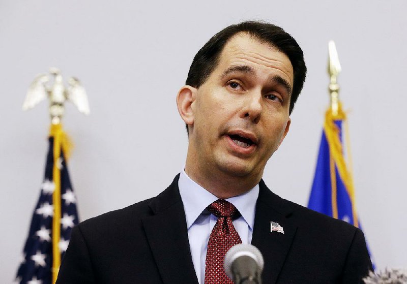 In this Sept. 21, 2015 file photo, Wisconsin Gov. Scott Walker announces in Madison, Wis. that he is suspending his Republican presidential campaign. 