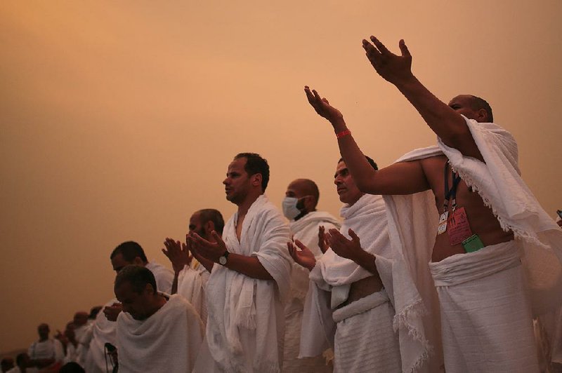 Muslim pilgrims pray Tuesday on the Mountain of Mercy, a rocky hill near the holy city of Mecca in Saudi Arabia. 