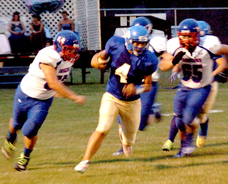 Photo by Mike Eckels Decatur quarterback Meng Vang (#4) breaks through the Mountainburg line during the Decatur Bulldog homecoming game at Bulldog Stadium Sept. 18. The Dragons defeated the Bulldogs, 49 to 0.