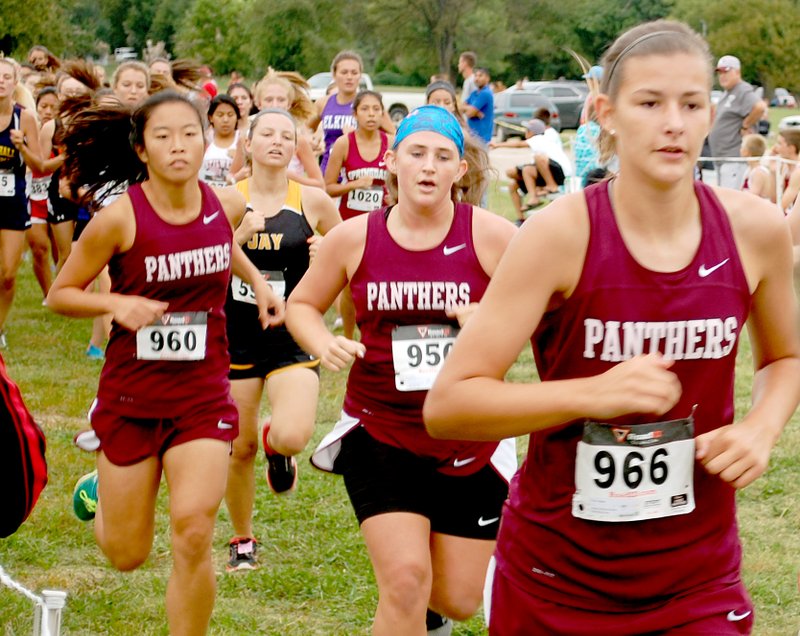 Graham Thomas/Herald-Leader Siloam Springs senior girls runners, from right, Megan Rush, Sidney Avery and Lin Lampton run in the Panther Cross Country Classic held Saturday at the Simmons Course.