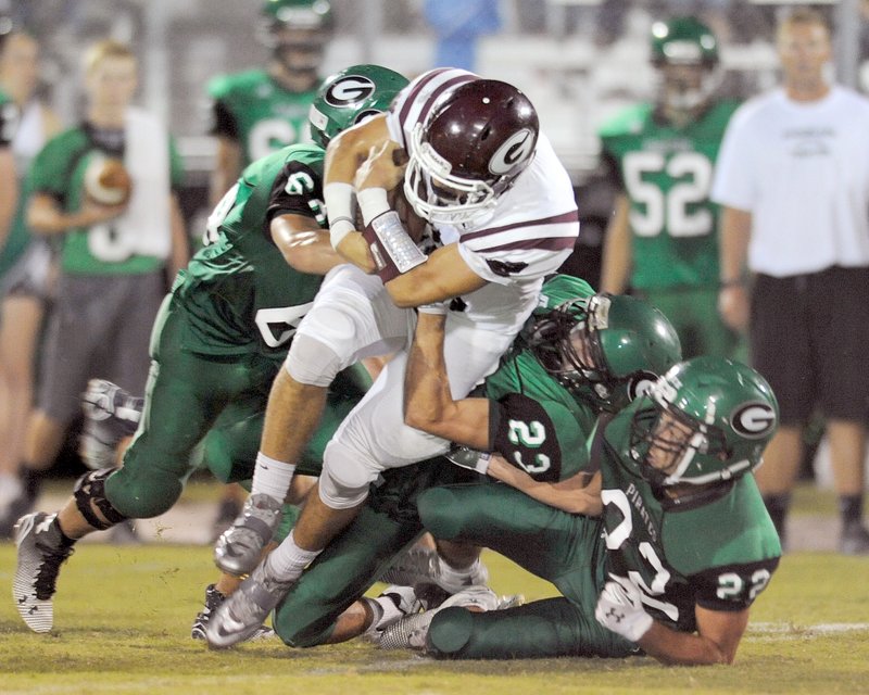 Paycen Dennis (23) of Greenland tackles C.J. Taylor of Gentry Friday during the first half of play at Jonathan Ramey Memorial Stadium in Greenland.