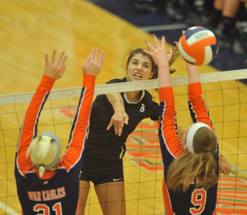 Sadie Pate of Bentonville hits the ball past Heritage defenders during Tuesday’s game at Heritage High School.