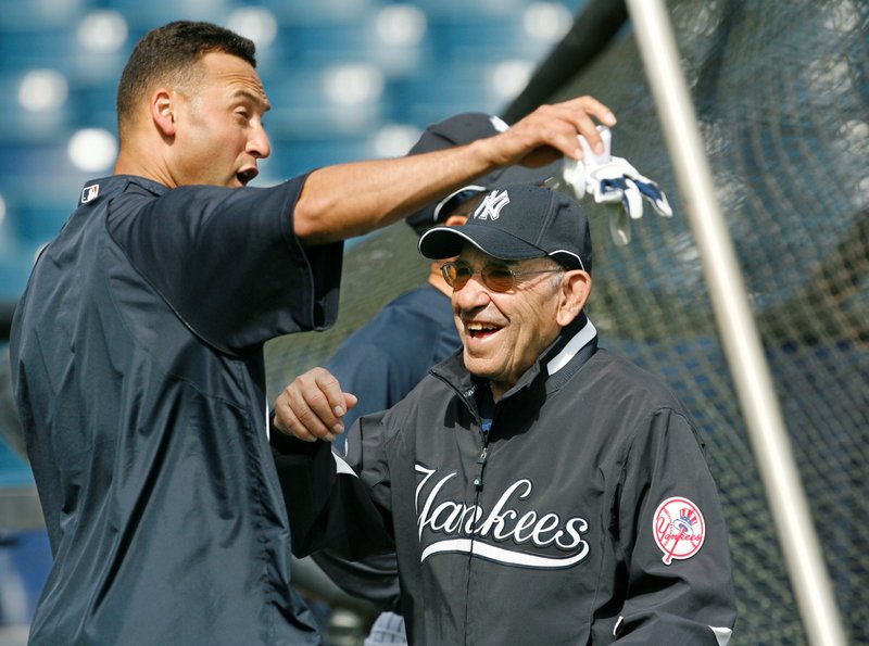 File-This March 7, 2008, file photo shows New York Yankees shortstop Derek Jeter, left, and Yogi Berra clowning around by the batting cage before the Yankees spring training baseball game against the Houston Astros at Legends Field in Tampa. Berra, the Yankees Hall of Fame catcher, has died. He was 90. (AP Photo/Kathy Willens, File)
