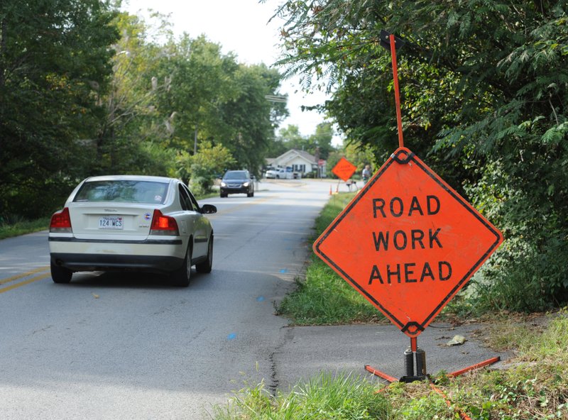 Traffic passes Tuesday along Old Wire Road in Fayetteville. Fayetteville’s Engineering Division is planning to add bike lanes, sidewalks, curb and gutter to the half-mile stretch of street. Construction is expected to begin in mid-2016 and take 12 months to complete.