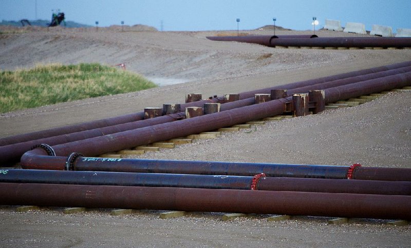 A pipeline leads to the Syncrude Canada Ltd. upgrader plant at the company’s facility near Fort McMurray, Alberta, in June. Canada’s finance minister said the nation’s energy sector is slowing Canadian economic growth, but that Canada is not in a recession. 