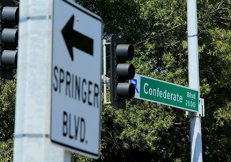 A Confederate Boulevard sign at Roosevelt Road hangs near a sign pointing toward Springer Boulevard on Wednesday in Little Rock. City officials are expected to consider a petition today to rename Confederate Boulevard’s last few blocks to Springer Boulevard.