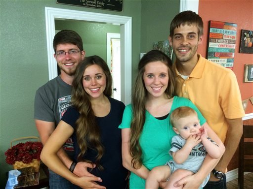 This image released by TLC shows, from left, Ben Seewald, Jessa Seewald, Jill Dillard holding her baby, Israel Dillard, and Derik Dillard. 