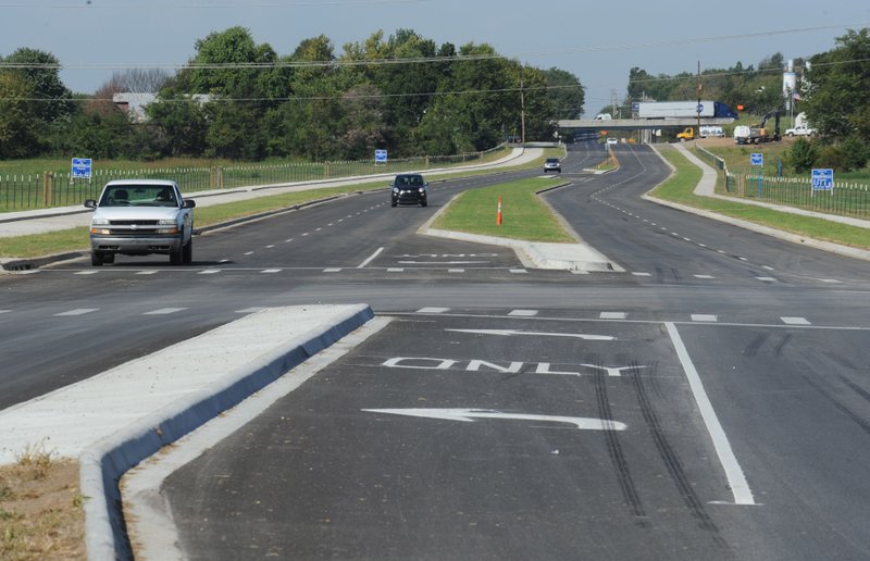Traffic flows Wednesday along Van Asche Drive after the opening of the nearly 1-mile stretch of road between Gregg Avenue and Arkansas 112. The $4.6 million project was completed by APAC-Central
