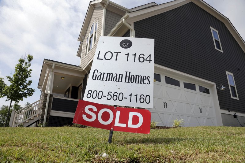 In this June 9, 2015 file photo, a sold sign is displayed in the yard of a newly built home in the Briar Chapel community in Chapel Hill, N.C. The Commerce Department reports on sales of new homes in August on Thursday, Sept. 24, 2015.