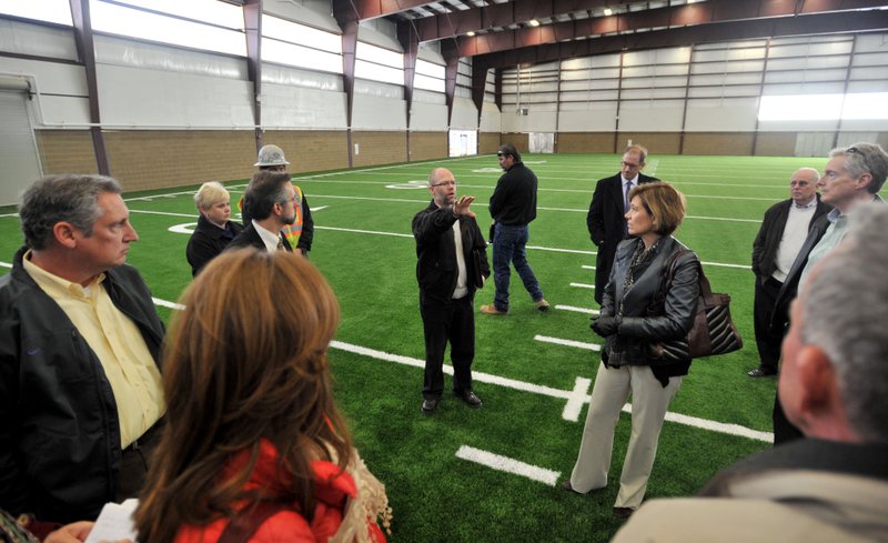 File Photo/MICHAEL WOODS Members of the Fayetteville School Board tour athletic facilities at the newly renovated high school.