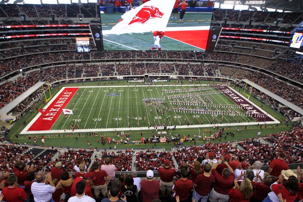 Fans cheer as the Razorbacks take the field at Cowboys Stadium before the 2011 Southwest Classic game between Arkansas and Texas A&M.