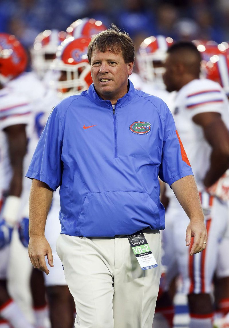 In this Saturday, Sept. 19, 2015, file photo, Florida head coach Jim McElwain watches his team warm up before an NCAA college football game against Kentucky in Lexington, Ky.