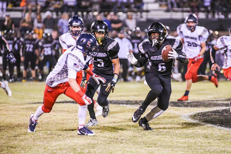 Pulaski Robinson running back T.J. Hammonds (6) sidesteps a Baptist Prep defender during the second quarter of Friday’s game at Charlie George Stadium in Little Rock. Hammonds rushed for 285 yards and 4 touchdowns on 13 carries. More photos from Friday’s games are available arkansasonline.com/galleries.