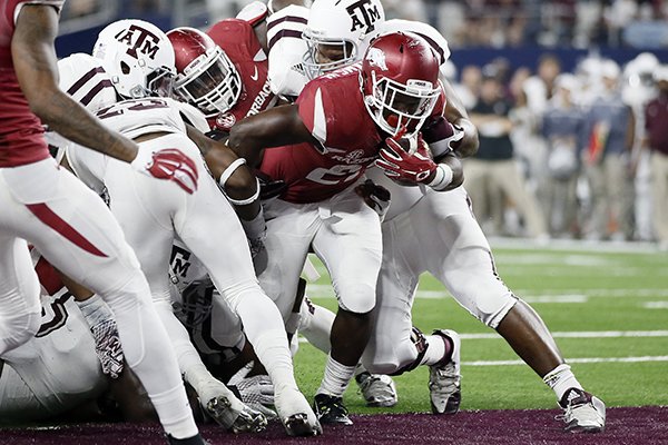 Arkansas running back Rawleigh Williams fights his way into the end zone for a touchdown against Texas A&M during the second half of an NCAA college football game on Saturday, Sept. 26, 2015, in Arlington, Texas. Texas A&M won in overtime, 28-21. (AP Photo/Tony Gutierrez)