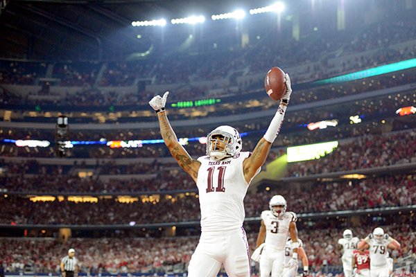 Texas A&M’S Josh Reynolds (11) celebrates after catching a pass for the tying 2-point conversion against Arkansas during the fourth quarter of an NCAA college football game Saturday, Sept. 26, 2015, in Arlington, Texas. Texas A&M won 28-21 in overtime. (Sam Craft/The Bryan-College Station Eagle)