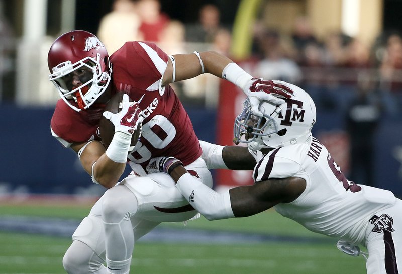 Arkansas wide receiver Drew Morgan (80) fights for extra yardage against Texas A&M defensive back Nick Harvey (8) during the first half of an NCAA college football game Saturday, Sept. 26, 2015, in Arlington, Texas. (AP Photo/Tony Gutierrez)
