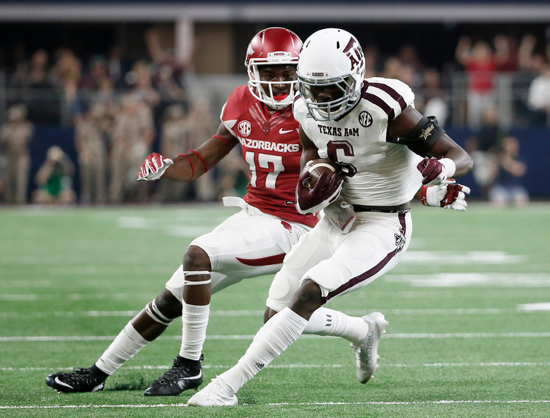Texas A&M defensive back Donovan Wilson (6) comes away with an interception on a pass intended for Arkansas wide receiver JoJo Robinson (17) during the first half of an NCAA college football game Saturday, Sept. 26, 2015, in Arlington, Texas. (AP Photo/Tony Gutierrez) 