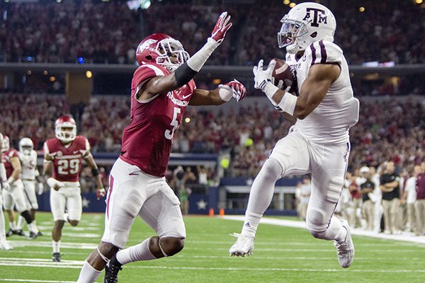 Texas A&M freshman wide receiver Christian Kirk makes a catch in the end zone by Arkansas sophomore cornerback Henre' Toliver on Saturday, Sept. 26, 2015, in overtime for the game-winning score at AT&T Stadium in Arlington, Texas.