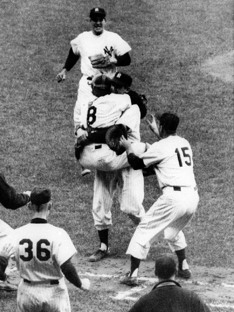 Yogi Berra (8) had a better statistical World Series in 1956, but the MVP was given to pitcher Don Larsen (hugging Berra) after he pitched a perfect game. 