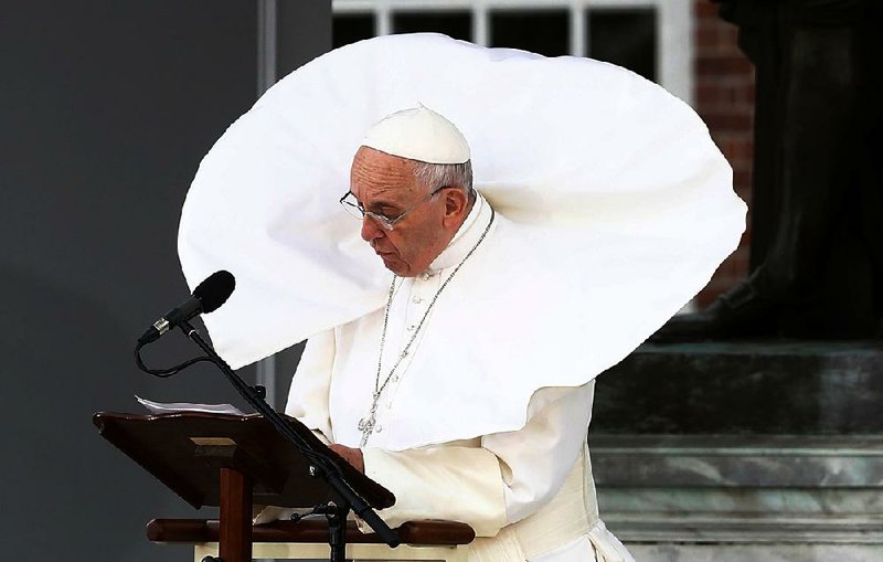 The wind lifts Pope Francis’ mantle as he speaks Saturday in front of Independence Hall in Philadelphia. He urged followers of all religions to espouse peace, tolerance and respect for others.