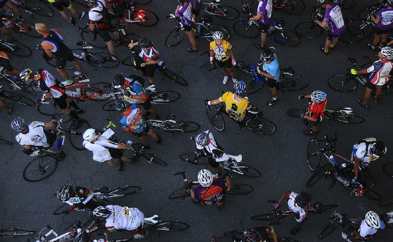 Riders wait Saturday morning to set off on the Big Dam Bridge 100 bike tour. Participants traversed routes of varying lengths, some up to 100 miles, for the central Arkansas event. More photos are available at arkansasonline.com/galleries 